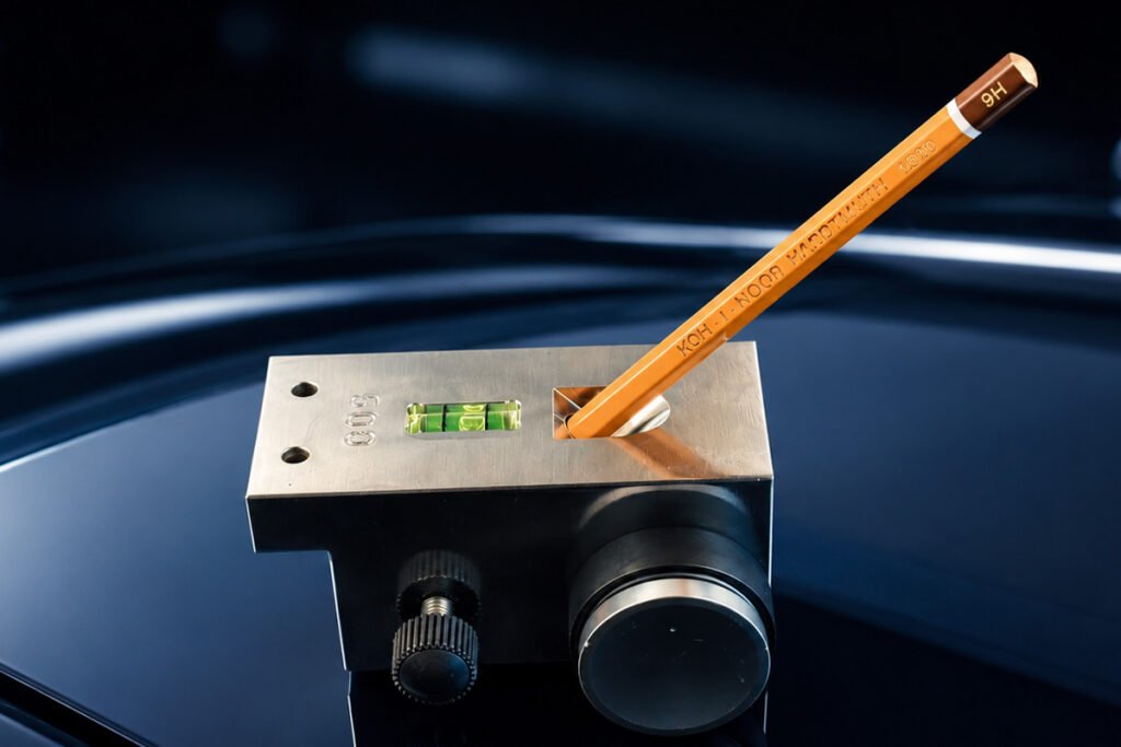 een potlood-test op donkere autolak met een 9h-potlood als test